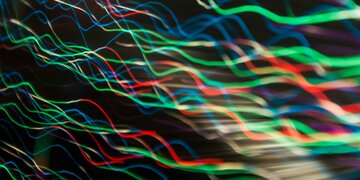 Waves of different coloured light on a black background.