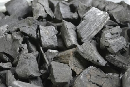 An image of blocks on charcoal stacked in a pile.