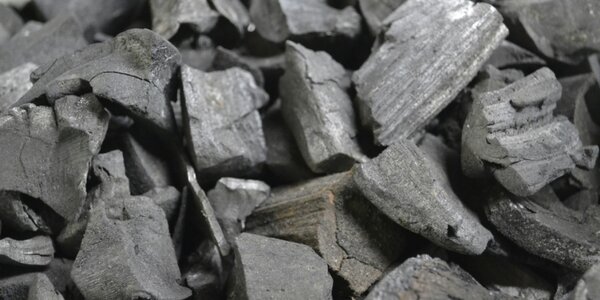 An image of blocks on charcoal stacked in a pile.